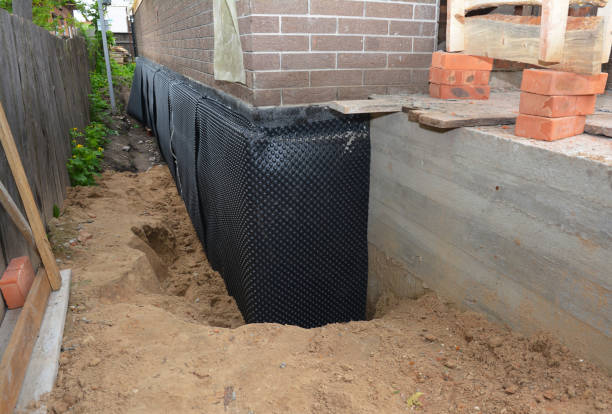 SJ Waterproofing Pros technician performing targeted Exterior Waterproofing assessment in Morrisonville, IL